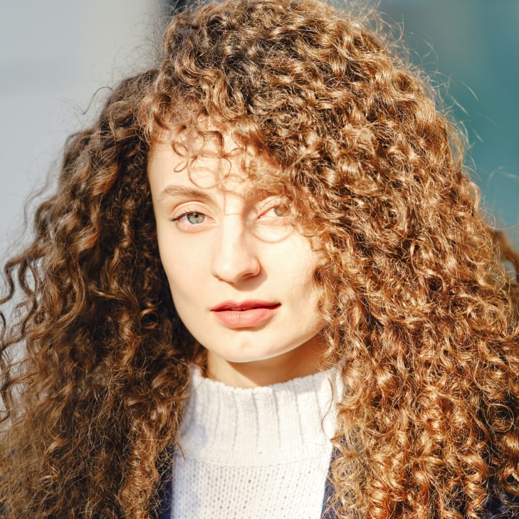 Portrait of a woman with brown curly hair